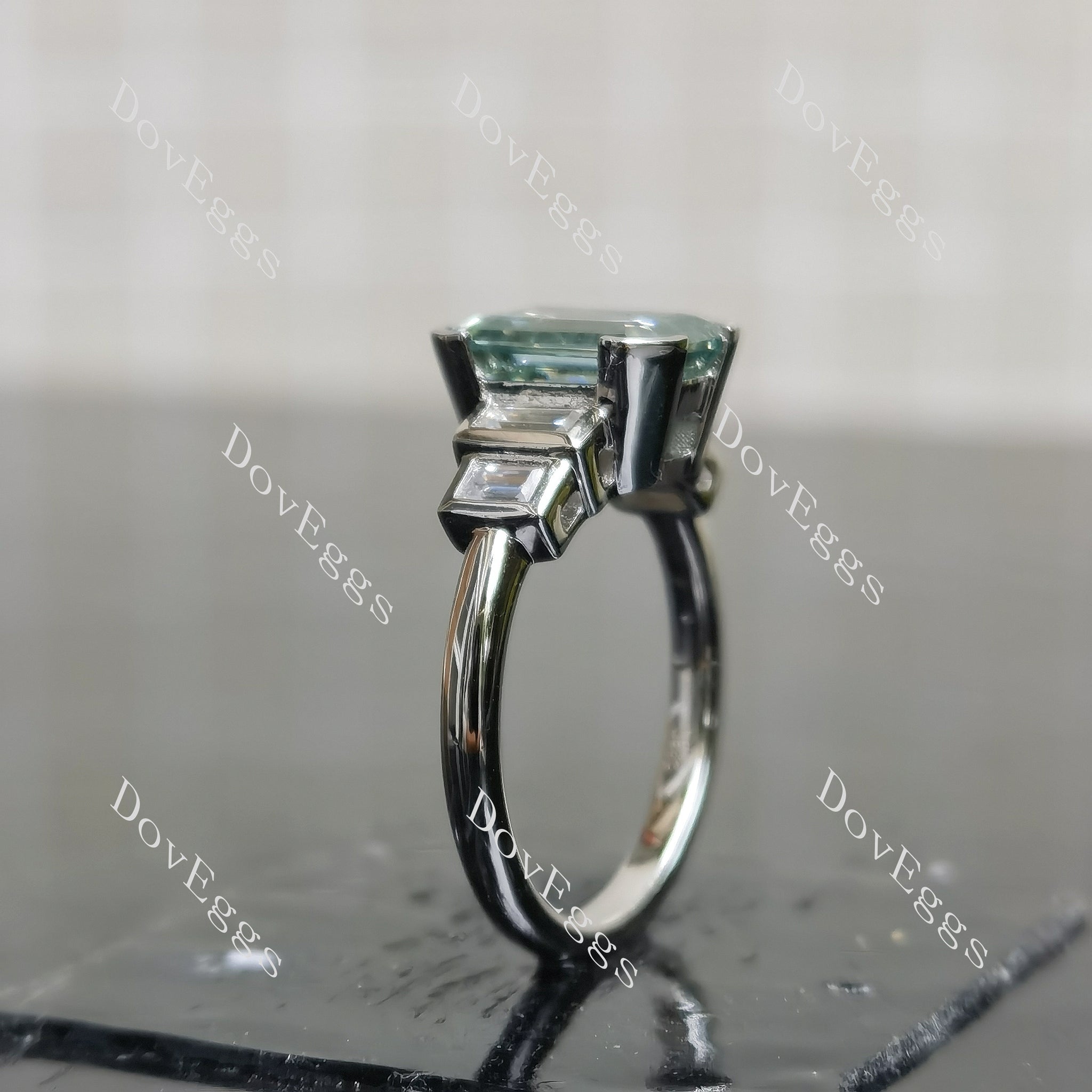 Doveggs emerald bezel side stones colored moissanite engagement ring