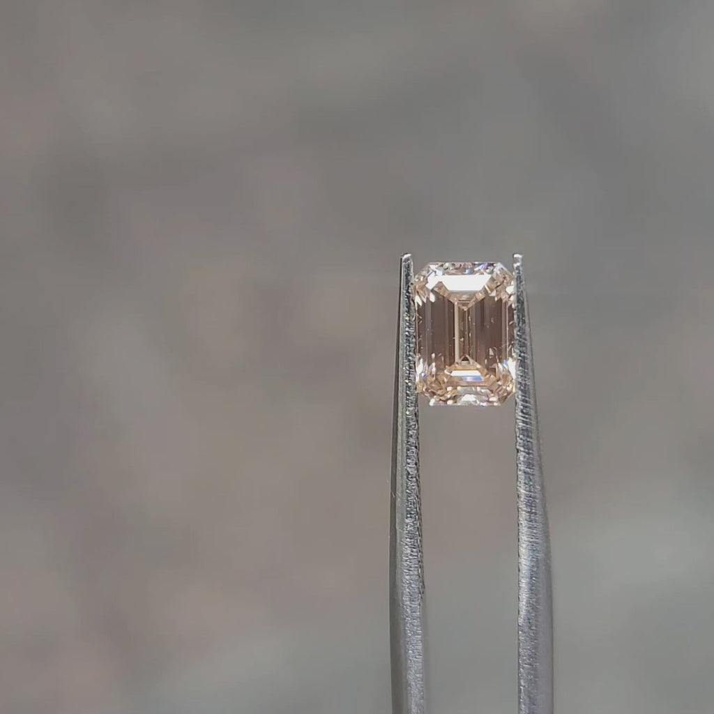 1.38ct Emerald lab diamond’s delicate orange sparkle outdoors